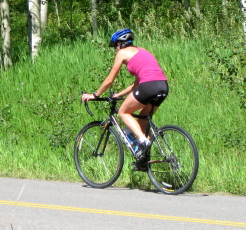 An athletic woman riding a bike