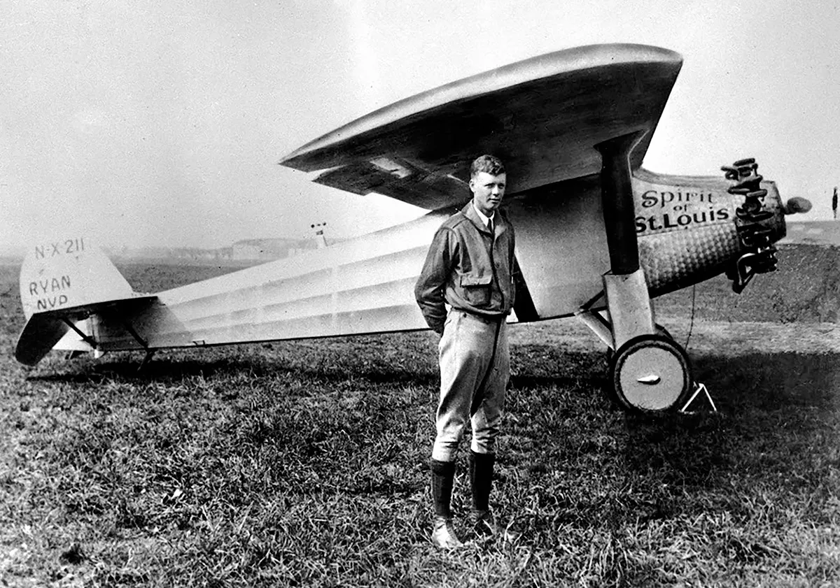 Charles Lindbergh standing beside the Spirit of St. Louis